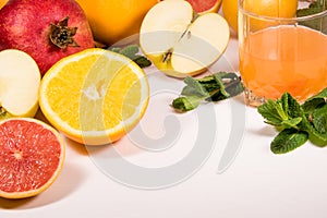 A vitamin set on a white background fruit and citrus apples grapefruit orange ginger mint and blander Healthy eating