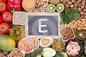 Vitamine E food sources, top view on wooden background photo