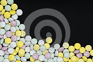 Vitamines, capsules, pills or tablets isolated on a black background. photo
