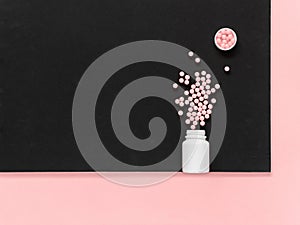 Vitamins. Antiviral drug tablets. Antidepressants. Round pink healthy pills and pill bottle on black and pink background