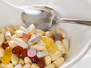 Vitamins in bowl of tablets