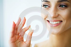 Vitamins. Healthy Eating. Happy Girl With Omega-3 Fish Oil Capsule. Healthy Diet Concept.