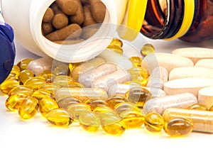 Vitamins, omega 3, cod-liver oil, dietary supplement and tablets an embankment on a light background close up