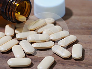 vitamins pills on wooden background