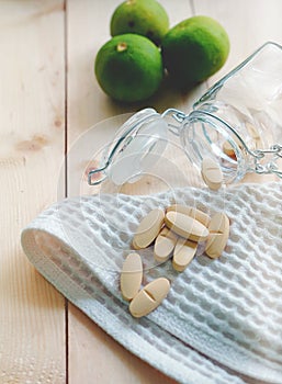 Vitamins and supplements in the bottle on wooden table