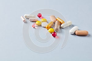 Vitamins and supplements on bright paper background. Concept for a healthy dietary supplementation.