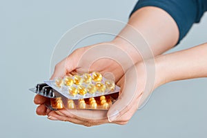 Vitamins And Supplements. Closeup Of Woman Hands Holding Variety Of Colorful Vitamin Pills. Close-up Handful Of Medication,