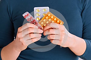 Vitamins And Supplements. Closeup Of Woman Hands Holding Variety Of Colorful Vitamin Pills. Close-up Handful Of Medication