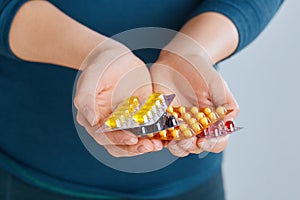 Vitamins And Supplements. Closeup Of Woman Hands Holding Variety Of Colorful Vitamin Pills. Close-up Handful Of Medication