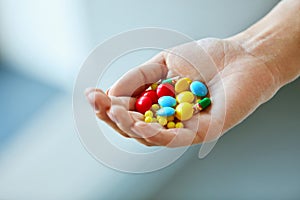 Vitamins And Supplements. Female Hand With Colorful Pills