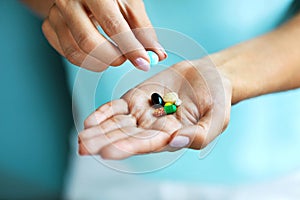 Vitamins And Supplements. Female Hand Holding Colorful Pills photo