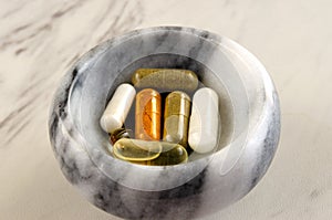 Vitamins and Supplements In Marble Bowl