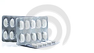 Vitamins and supplements tablets in blister pack on white