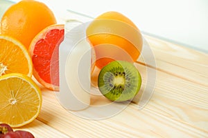 Vitamins. White empty bottle for vitamins on a background of citrus fruit slices. lemon. orange. White background. Blank Medicine