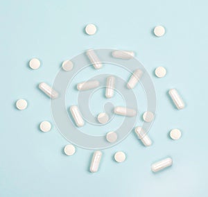 Vitamins in white tablets on a blue background