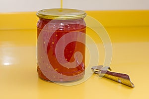 Vitamins on yellow table, tomato paste in glass jar and can opener