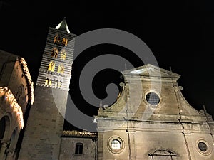 Viterbo ancient city by night, church and tower, darkness and lights, religion and sky