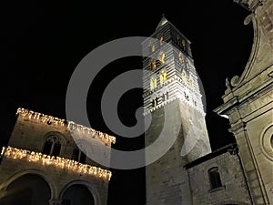 Viterbo ancient city by night, church and tower, darkness and lights, religion and sky