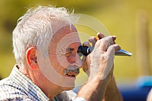 Viticulturist analyzing sugar with refractometer