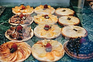 Vitrine at French bakery with delicious desserts for sale