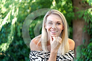 Vivacious blond woman laughing at the camera