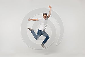 Vivacious fellow look at camera jumping isolated on grey background