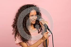 Vivacious young black girl with a microphone