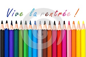 Vive la rentree (meaning Back to school) written on white background with colorful wooden pencils photo