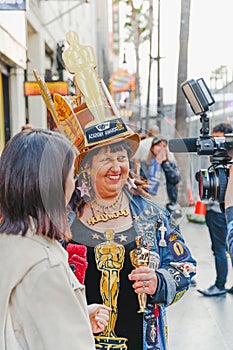 Vivianne Robinson, a big fan of Oscars ceremonies,  poses for tourists and photographers near the red carpet area on Hollywood Bl