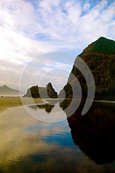 Haystack Rock Reflection in Sand Vertical photo