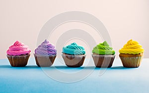 Vivid colous cupcake in a row, choice concept