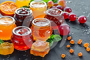 A vivid display of assorted fruit jams and golden honey jars