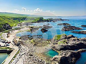 Vivid emerald-green water at Ballintoy harbour along the Causeway Coast in County Antrim