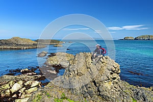 Vivid emerald-green water at Ballintoy harbour along the Causeway Coast in County Antrim. Rugged coast of Northern Ireland