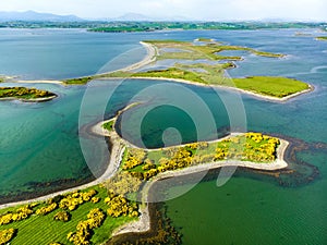 Vivid emerald-green waters and small islands near Westport town along the Wild Atlantic Way, Ireland.