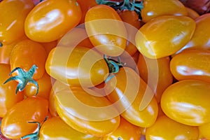 Vivid orange cherry tomatoes top view closeup