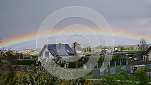 A vivid rainbow over small vilage