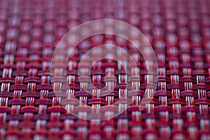 Vivid red basket weave mesh texture background with limited focus