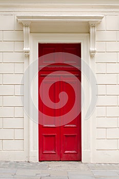 Vivid red door on a white wall