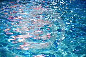 Vivid Red Lights Reflection on Wavy Blue Water Surface