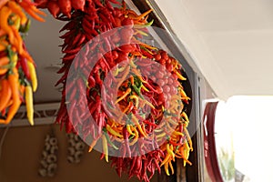 Vivid shot of chili peppers hanging on display in a shop in Amalfi Coast, Italy