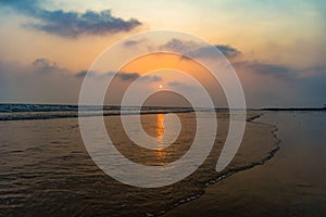 Vivid sunrise on a serene calm tranquil deserted beach at digha