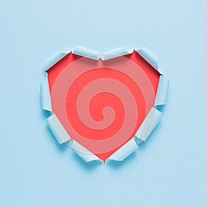 Vivid torn paper heart on bright background. Minimal love or like concept.