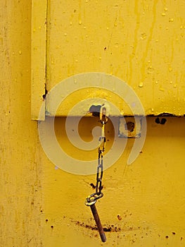 vivid yellow abstract design on a rusty metal surface