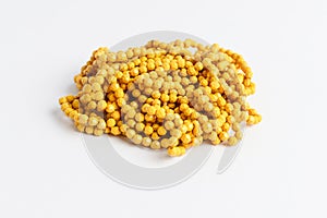 Vivid yellow colored plastic beads isolated on white, ready to be used for handmade objects and projects, photographed with select