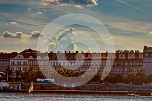 Vlatava shores with boat and houses with clouds in Prague