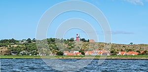 Vlieland with Vuurduin lighthouse on vuurboetsduin and East-Vlieland town from Waddensea, Friesland, Netherlands photo