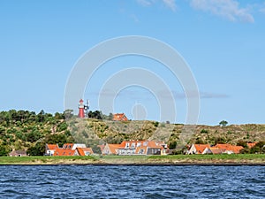 Vlieland with Vuurduin lighthouse on vuurboetsduin and East-Vlieland town from Waddensea, Friesland, Netherlands photo