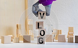 vlog - name from wooden letters. Office desk, informative and communication background