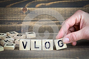 Vlog. Wooden letters on the office desk, informative and communication background